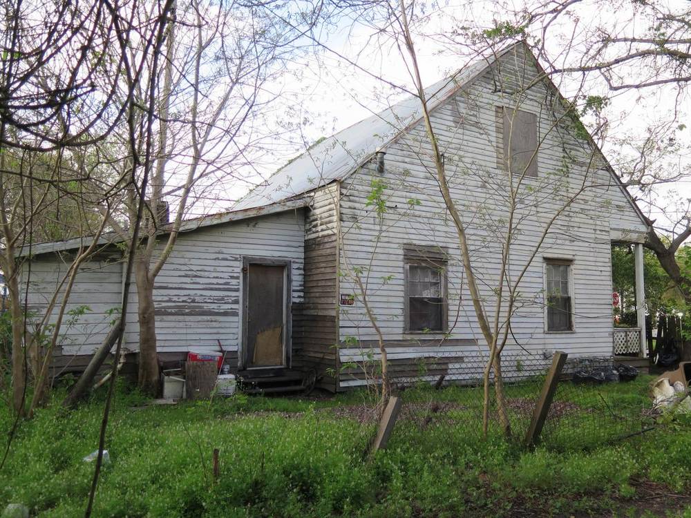 Overgrown Warren Street cottage before restoration, south side